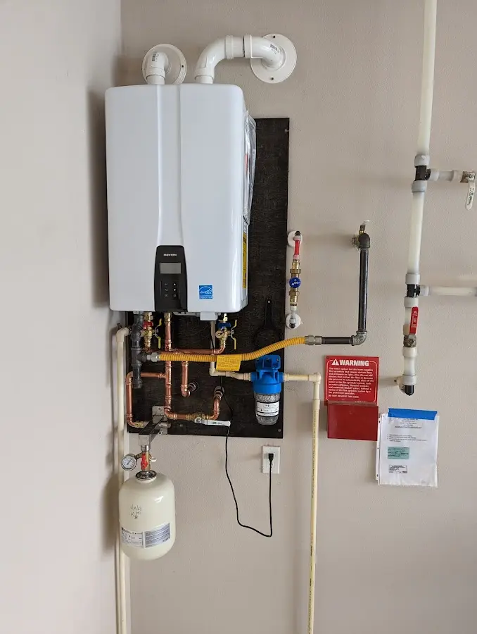 Professional plumber installing copper piping in a Felida home